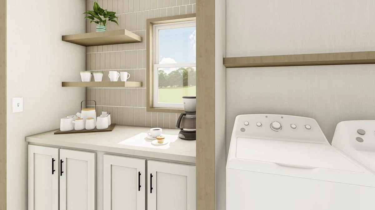 A laundry room with a washer, dryer, sink, coffee maker, mugs, and shelves holding dishes and a potted plant near a window.