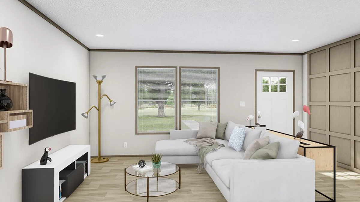 Modern living room with a white sectional sofa, TV on the wall, floor lamps, a round coffee table, and large windows showing a view of greenery outside.