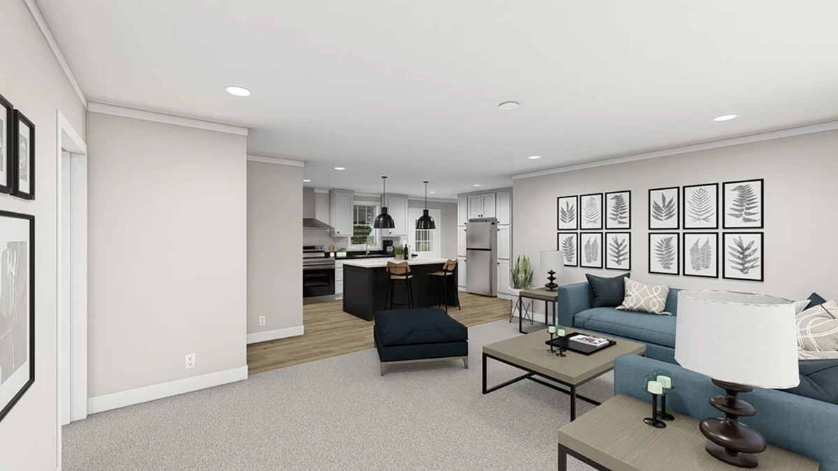 9daad9ad-3d8d-4550-9b2c-5ddc111e9cb8 A modern open-plan living room and kitchen with neutral walls, blue sofa, wall art, kitchen island with stools, and stainless steel appliances.