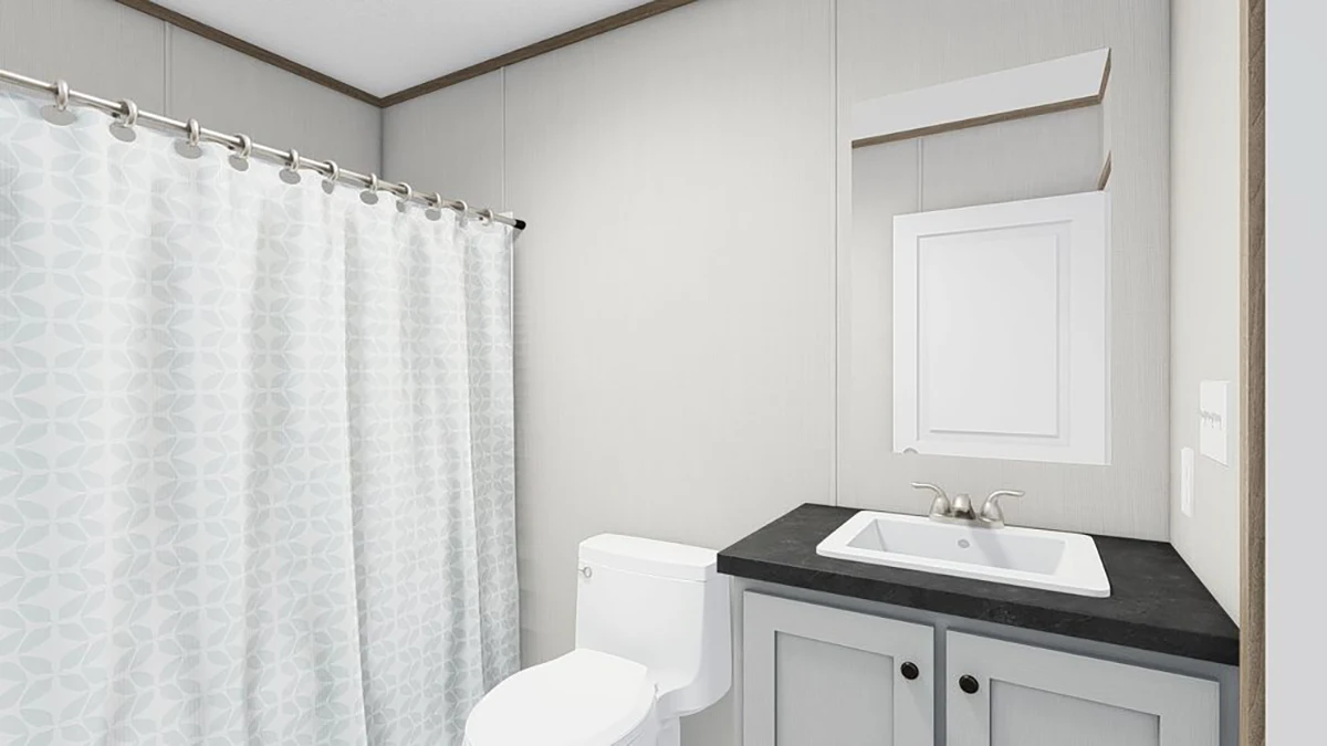 A bathroom with a white shower curtain, a toilet, a sink with a black countertop, and a wall-mounted mirror above the sink.