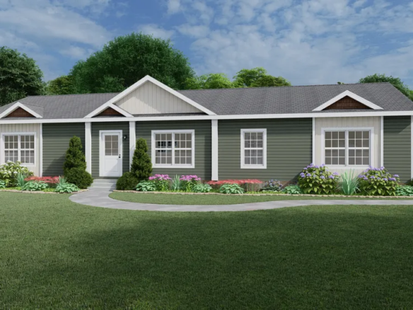 Single-story green house with white trim, gabled roof, multiple windows, and landscaped front yard with shrubs and flowers under a partly cloudy sky.