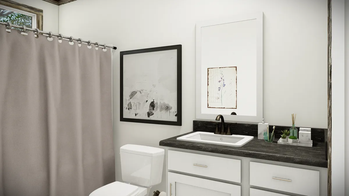 Modern bathroom with white walls, a sink with black faucet, a toilet, a beige shower curtain, and framed abstract art above the vanity and beside the shower.