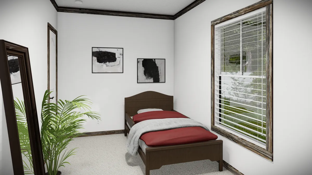 A small bedroom with a single bed, red blanket, large window with blinds, two abstract paintings, a floor mirror, and a potted plant.