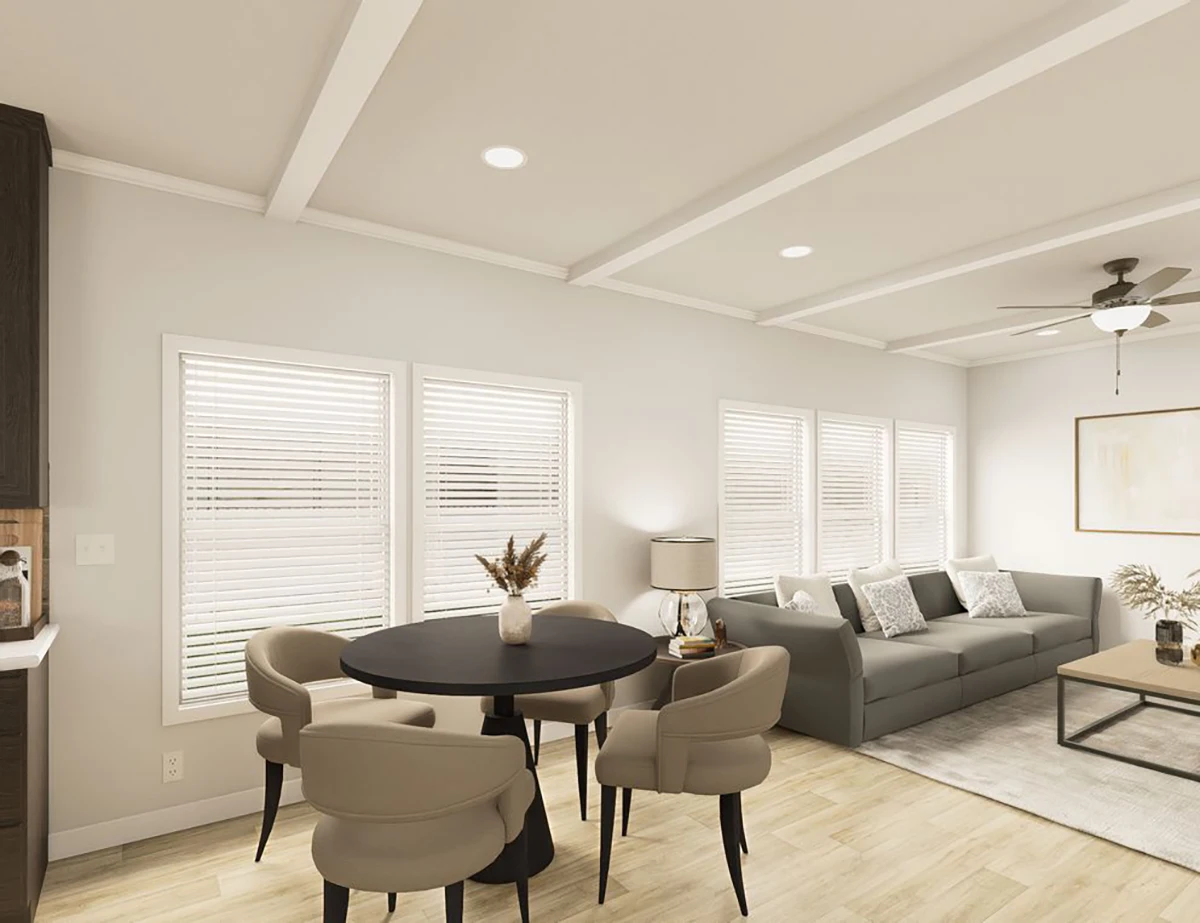 The Elite 52 18 A modern living and dining area with a round black table, four beige chairs, gray sofa, coffee table, and large windows with white blinds.