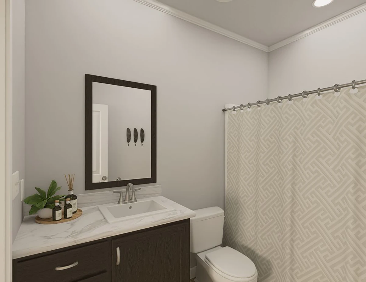 The Elite 52 21 Modern bathroom with a marble countertop, dark wood vanity, rectangular mirror, toilet, and patterned shower curtain. Decorative items and toiletries are placed on the counter.