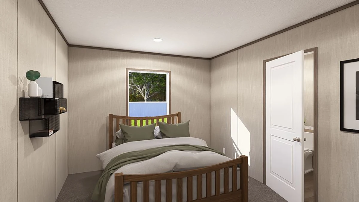 A small bedroom with a wooden bed, white bedding with green accents, beige walls, a window, open door, wall shelves, and framed picture.
