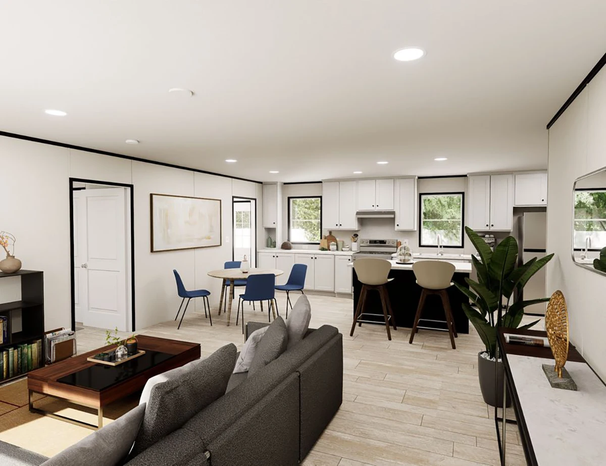 a6627bf4-fd22-49e4-b9f5-27b74ee1b185 Open-plan living space with a gray sofa, dining table with blue chairs, kitchen island with barstools, and white cabinets. Large windows provide natural light; plants and decor are visible.