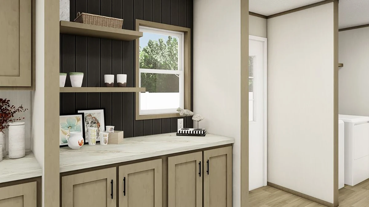 A countertop with cabinets below and open shelves above, set against a dark accent wall with a window; various small decor items are displayed.
