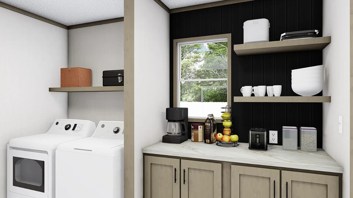 Laundry room with a washer and dryer on the left, and a countertop with kitchen appliances, fruit, and shelves with cups and containers on the right.