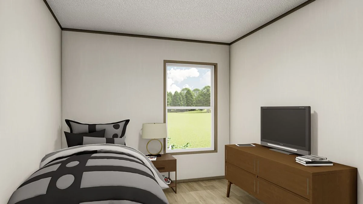a950a30e-c125-4138-9833-b6480565b607 A small bedroom with a single bed, a nightstand with a lamp, a window with a view of trees, a wooden dresser, and a flat-screen TV.
