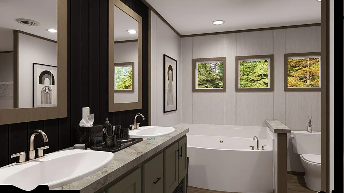 Modern bathroom with double sinks, a corner bathtub, a toilet, three windows, and framed artwork on white and dark walls.