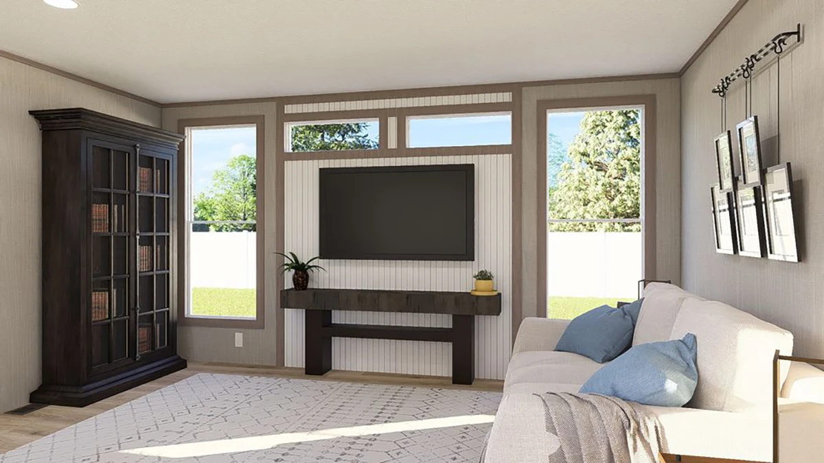bbc92eef-4cc1-46d2-942c-2b50c239ff23 A living room with a wall-mounted TV, a sofa with blue and beige pillows, a dark wood cabinet, and a console table with plants, set against large windows showing a green yard.