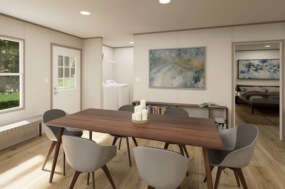 A modern dining area with a wooden table, six gray chairs, candles, a bench by the window, and a view into a laundry room and a bedroom. Contemporary art hangs on the walls.