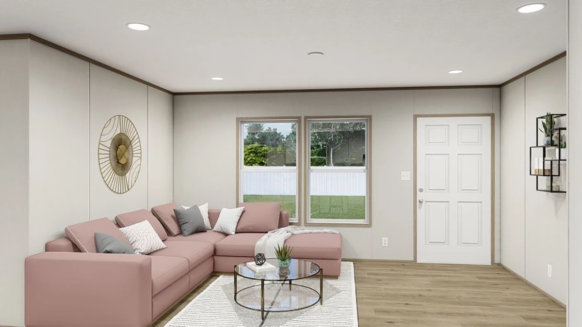 bd624bda-dff5-4cc5-a52d-84249435c5d3 Modern living room with a pink sectional sofa, decorative pillows, glass coffee table, wall art, large window, and a white door. Light wood floors and neutral walls.