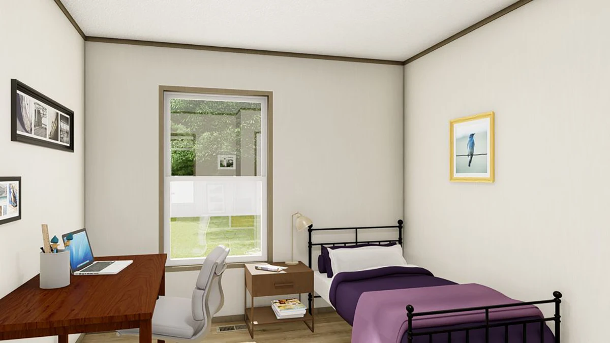 A small bedroom with a single bed, desk with a laptop, chair, nightstand, and wall art. A window lets in natural light and shows greenery outside.