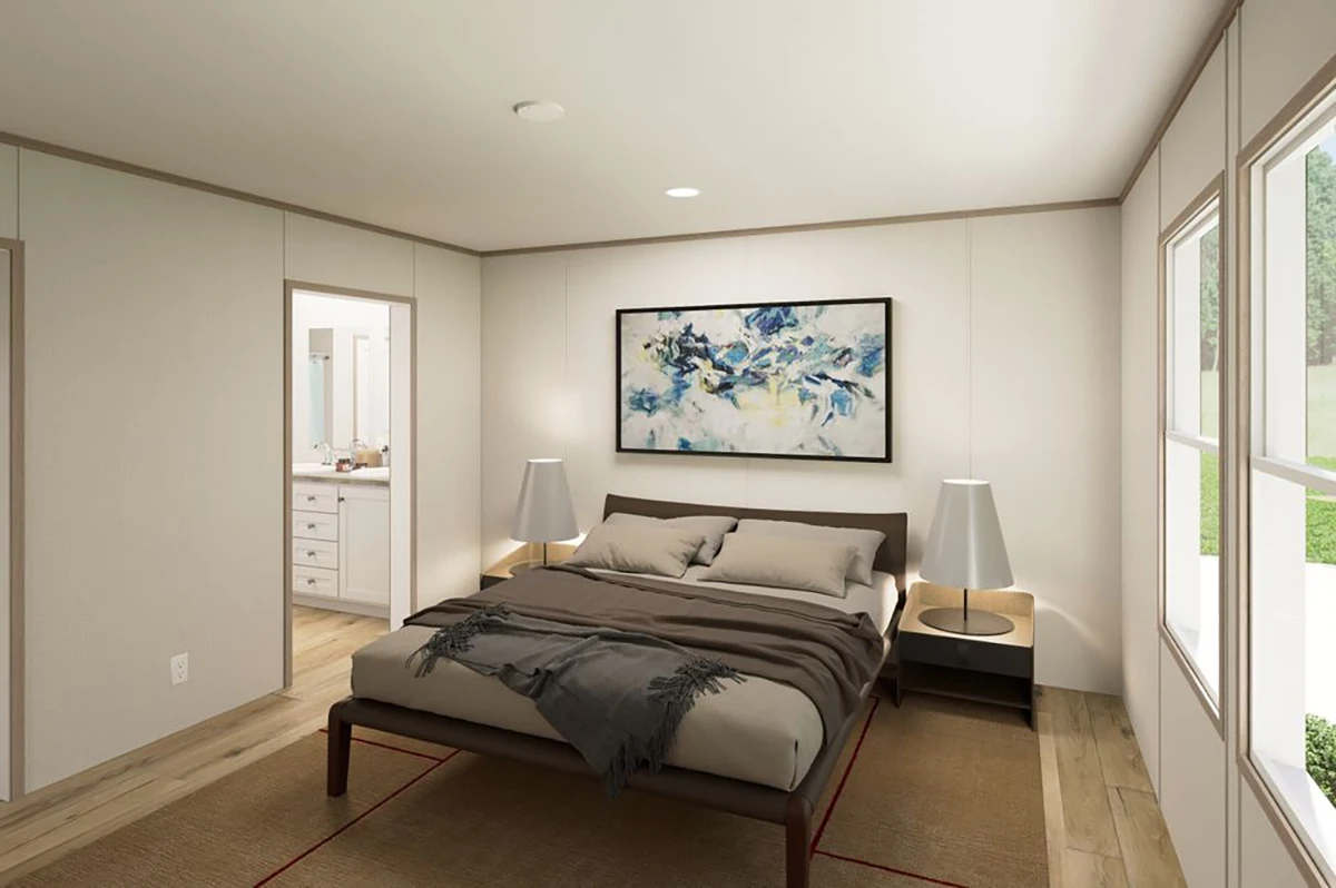 A modern bedroom with a large bed, two side tables with lamps, abstract artwork above the headboard, and an adjoining bathroom visible through an open door.