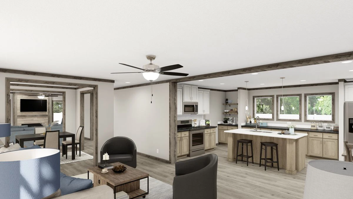 Open-concept living area with a kitchen, island seating, dining table, modern furnishings, ceiling fan, and large windows letting in natural light.