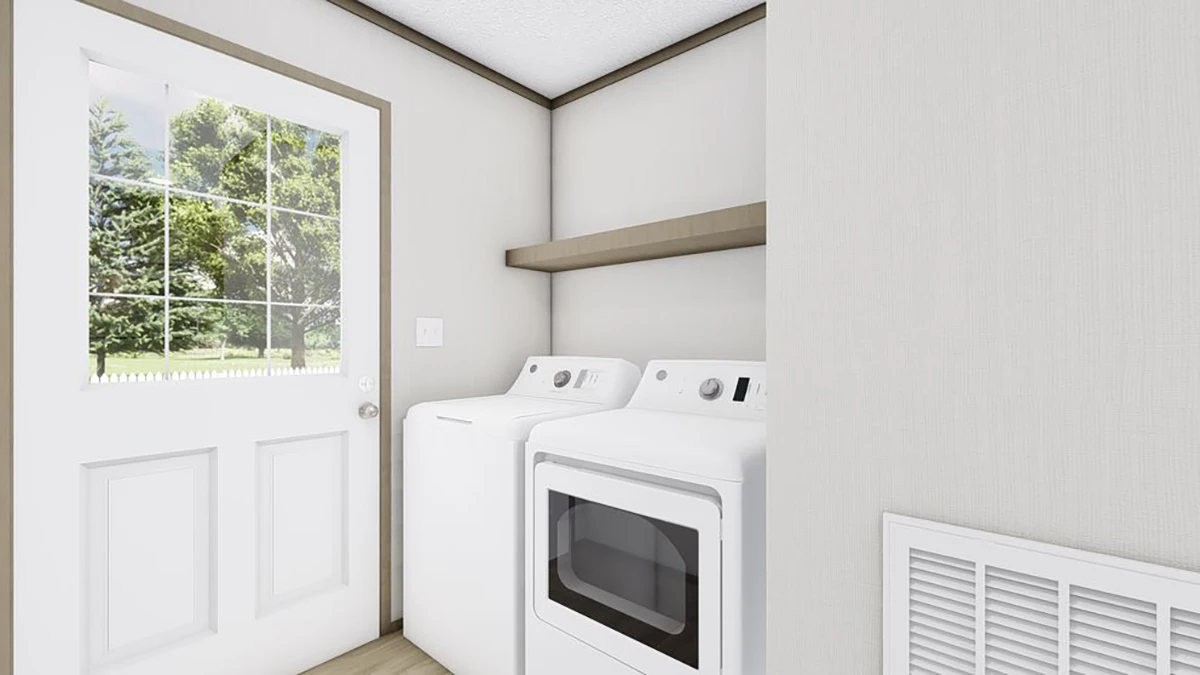 A laundry room with a washing machine and dryer side by side, a shelf above them, and a door with a window showing trees outside.