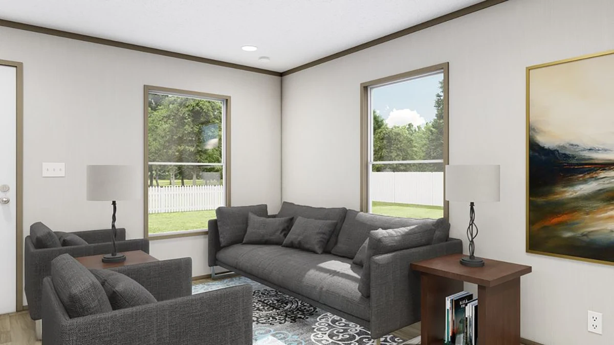 c3d99297-c361-4801-aae5-2a3301ae6f2b A living room with two windows, gray sofa and chairs, two lamps on side tables, a rug, and a large painting on the wall. Trees and a white fence are visible outside.