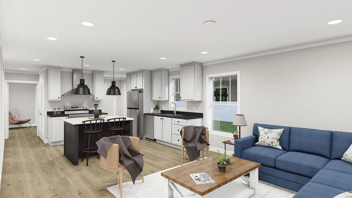 Modern open-concept kitchen and living room with white cabinets, black island, stainless steel appliances, blue sofa, and wooden floors.