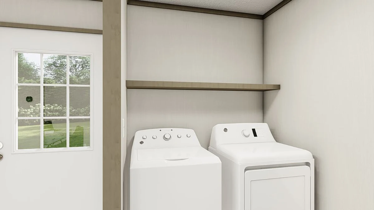 A laundry room with a washing machine and dryer side by side beneath a wooden shelf, next to a door with a window.