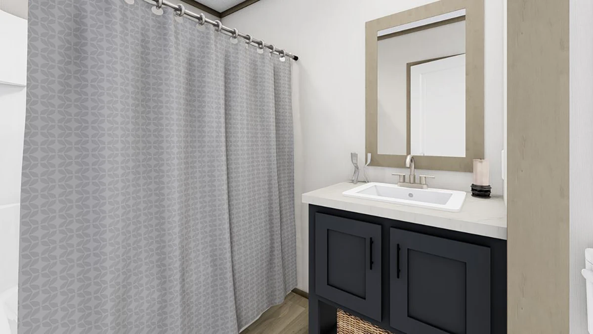 Modern bathroom with a gray patterned shower curtain, a white sink on a dark vanity, a rectangular mirror, and light-colored walls.