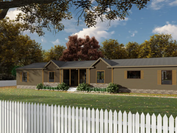 Single-story brown house with a covered porch, stone foundation, and large windows, surrounded by a white picket fence and trees with autumn foliage.