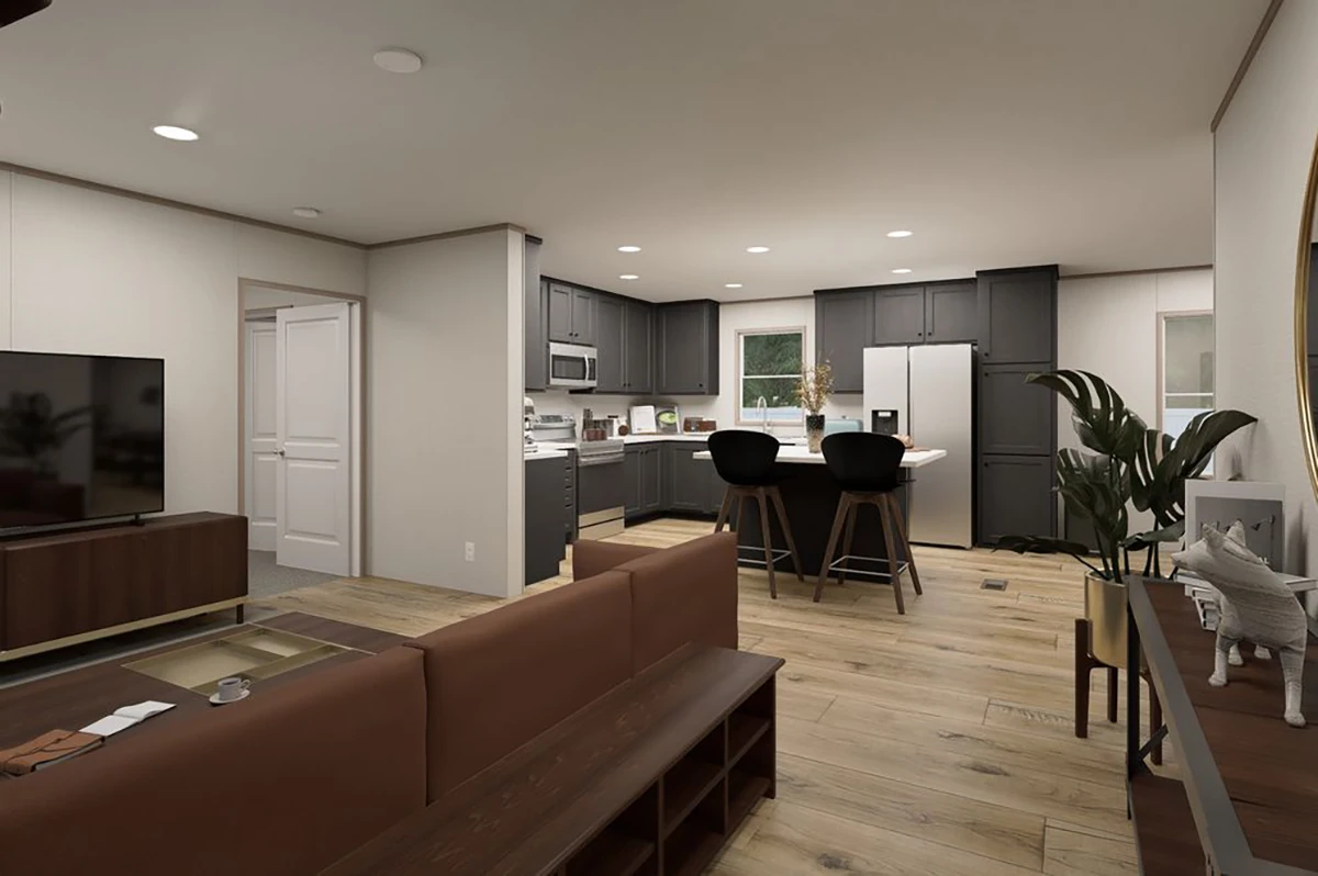 cc9e1080-3999-4bea-9a50-a7172b1c307f Modern open-plan living room and kitchen with wooden floors, brown sofa, dark cabinets, island with barstools, plants, and natural lighting.
