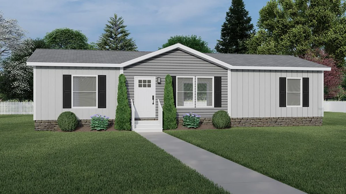 A single-story manufactured home with gray siding, black shutters, a small front porch with steps, and neatly trimmed shrubs in the yard.