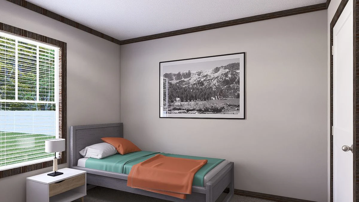 d38b766d-4019-4b3d-bebb-60b39c1fab5c A small bedroom with a single bed, teal and orange bedding, a nightstand with a lamp, a window with blinds, and a framed black-and-white mountain photo on the wall.