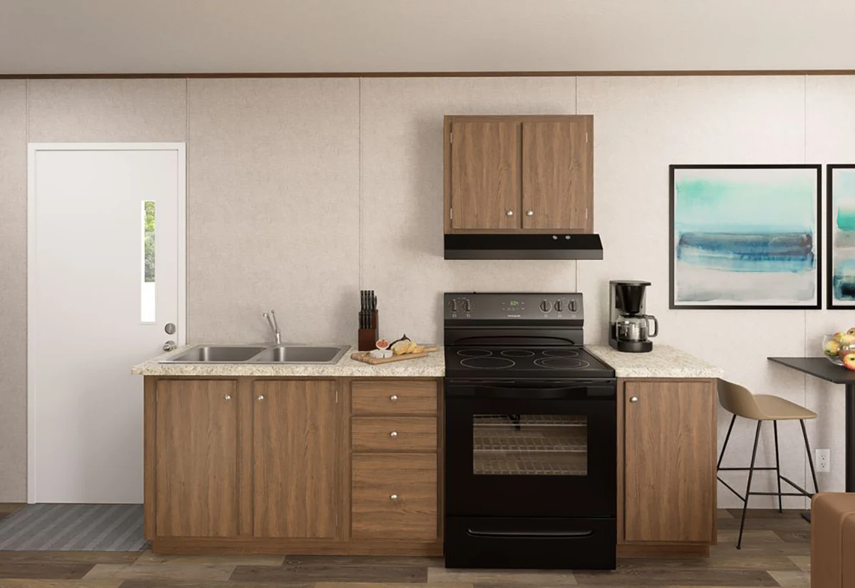 Modern kitchen with wood cabinets, black stove and hood, dual sink, coffee maker, and wall art. A door with a window is on the left, and two stools are at the counter on the right.