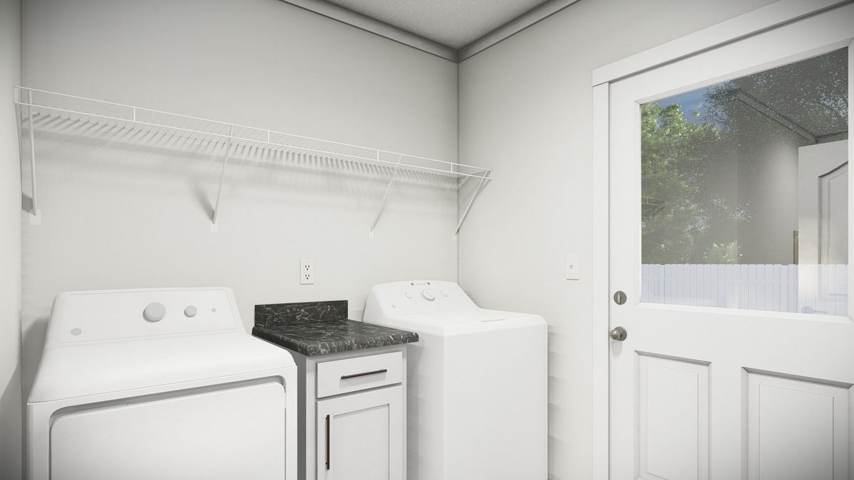 d78865fb-81eb-4736-b6cd-a1cb70b1e164 A laundry room with a washing machine, dryer, small counter with cabinet, wire shelf above, and a glass door leading outside.
