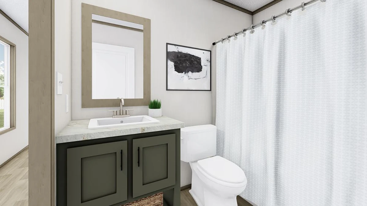 A modern bathroom with a green vanity, rectangular mirror, white sink, toilet, wall art, potted plant, and a white shower curtain on a rod.