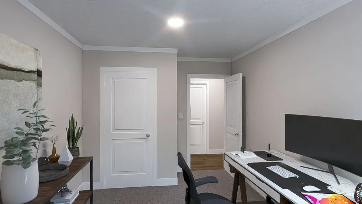 A home office with a desk, computer monitor, keyboard, chair, shelves with plants, and closed doors in the background under ceiling lighting.