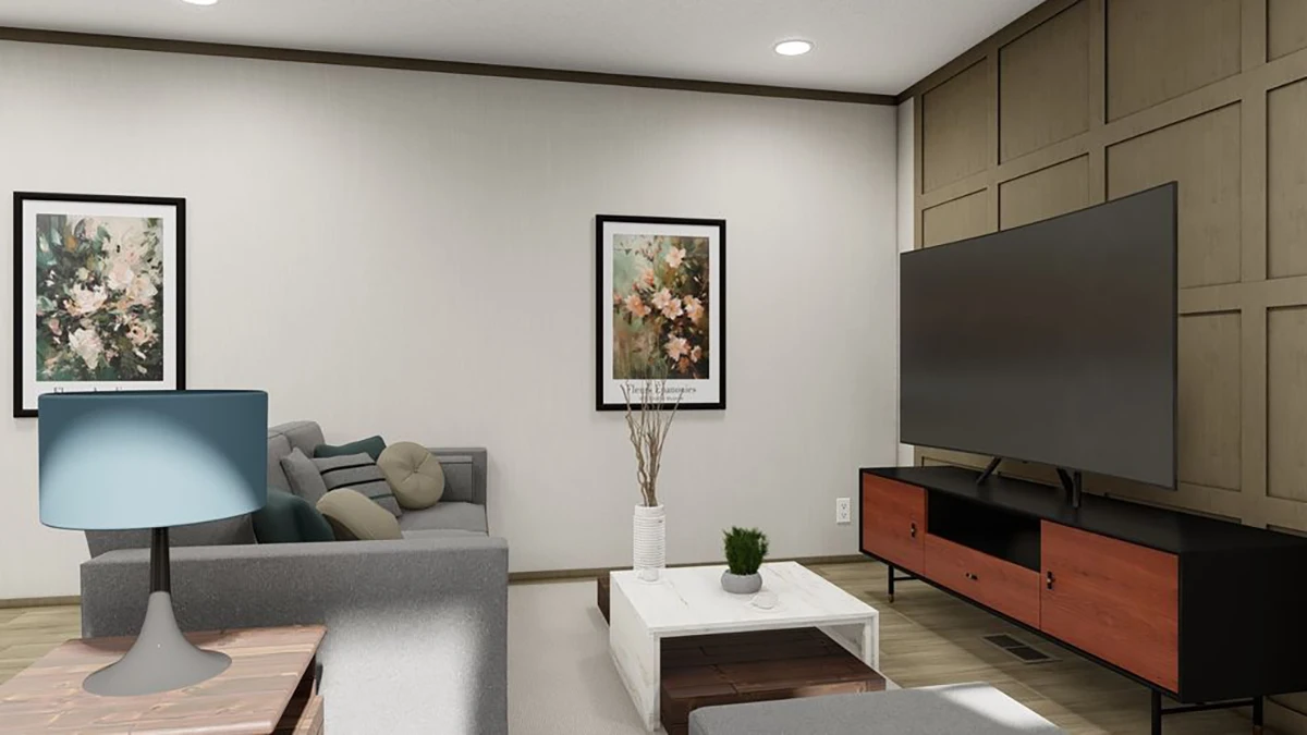 Modern living room with gray sofas, a large flat-screen TV on a wooden stand, a white coffee table, and framed floral artwork on the walls.