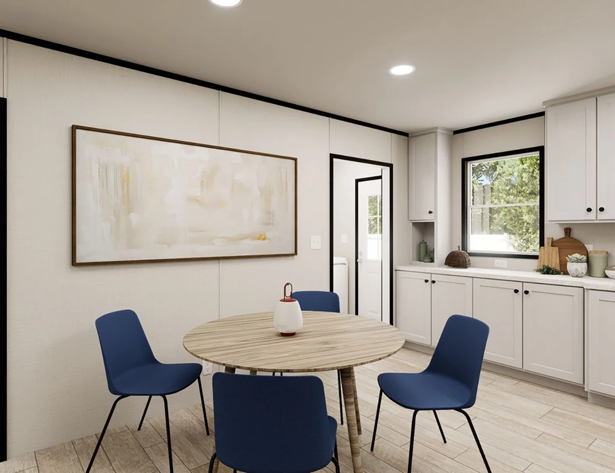 da7fecca-3a8e-4acd-ab61-efa93738707f A modern kitchen with white cabinets, a round wooden table, four blue chairs, a teapot centerpiece, and a large abstract painting on the wall.