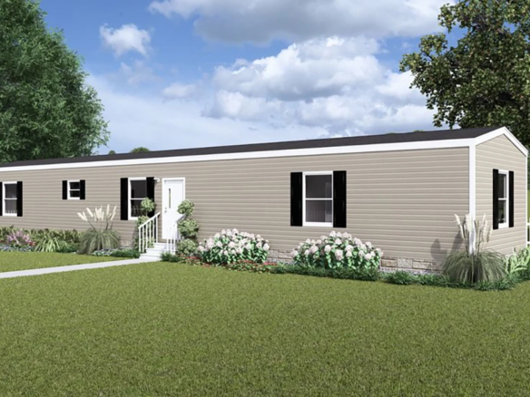 A beige manufactured home with black shutters, white trim, front steps, and landscaping, set on a grassy lawn with a white picket fence and trees in the background.