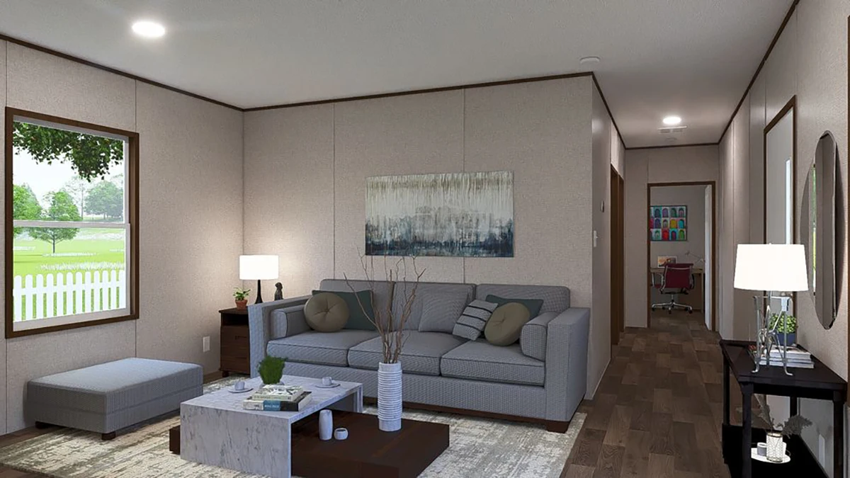 Modern living room with a gray sofa, abstract wall art, coffee table, and lamps; a hallway leads to a distant room with a desk and chair.