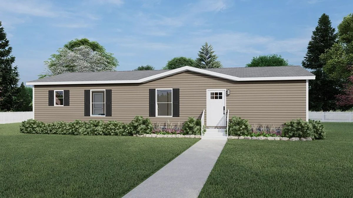 Single-story manufactured home with beige siding, black shutters, a small front porch, and a concrete walkway, set in a grassy yard with shrubs and trees.