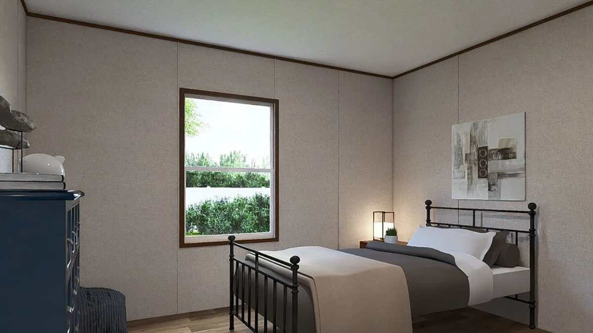 defeb463-f652-4fa8-83df-d053a7ba147b A simple bedroom with a double bed, gray bedding, a window with a view of greenery, a blue dresser, a lamp, and abstract art on the wall.