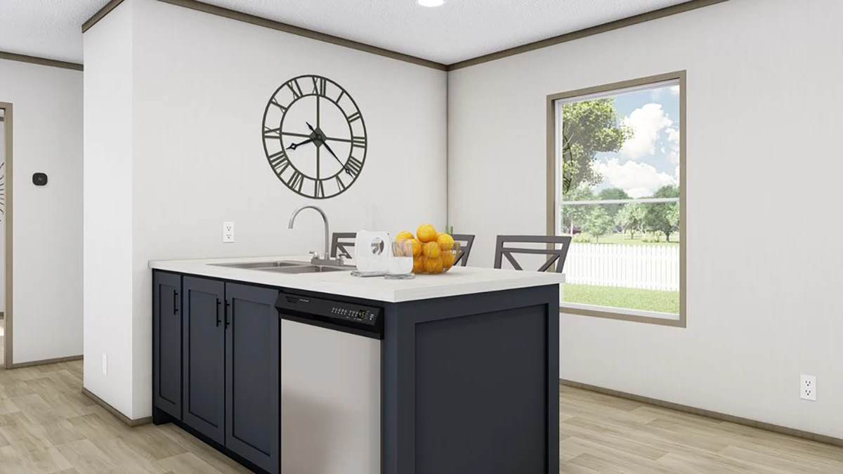 Modern kitchen with a navy blue island, stainless steel dishwasher, sink, chairs, a bowl of oranges, wall clock, window, and light wood flooring.