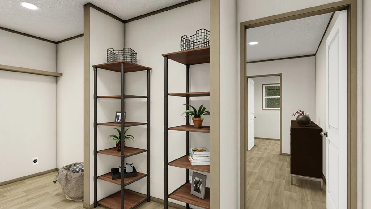 e0b5f74d-ef46-48a5-8455-b2c8c3dc9b80 Open shelving unit with decor items stands against a beige wall in a hallway with wood flooring; a laundry basket and dresser are visible in adjacent rooms.