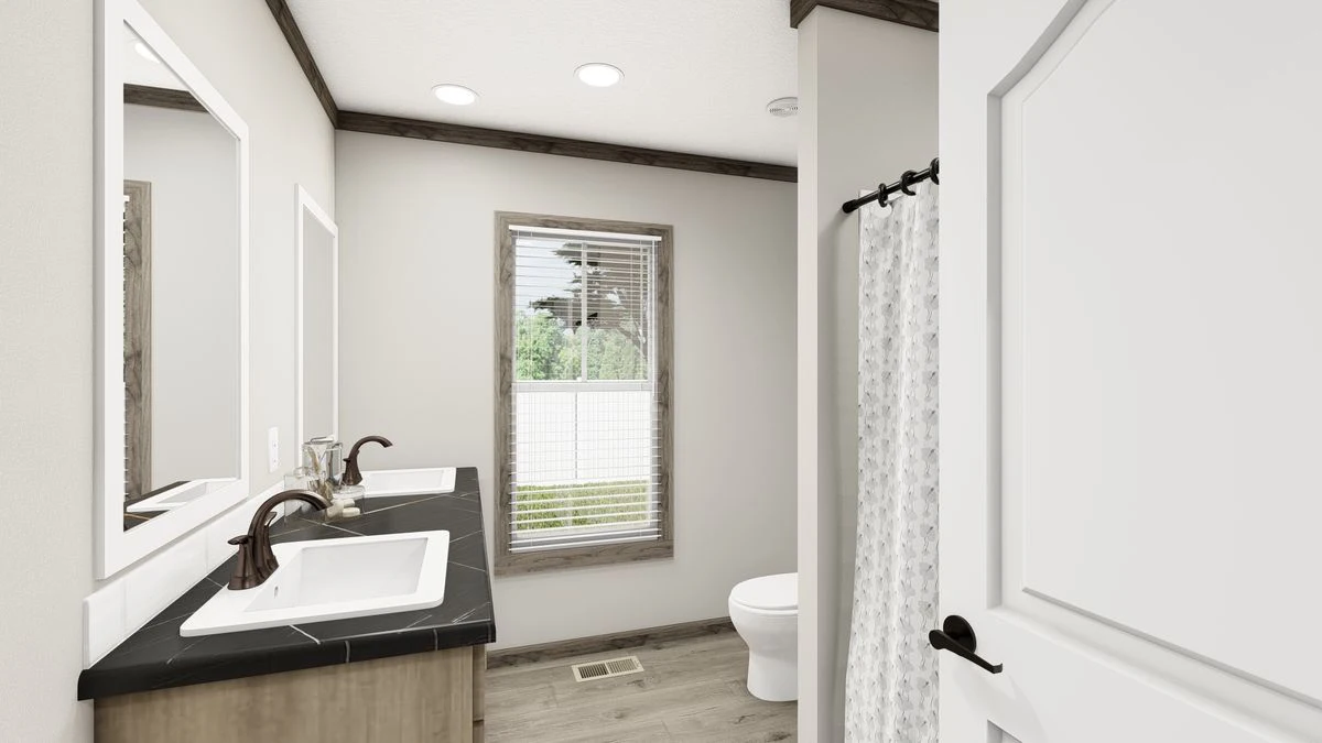 A modern bathroom with a double sink vanity, black countertop, large mirror, white toilet, window with blinds, and a shower with a patterned curtain.