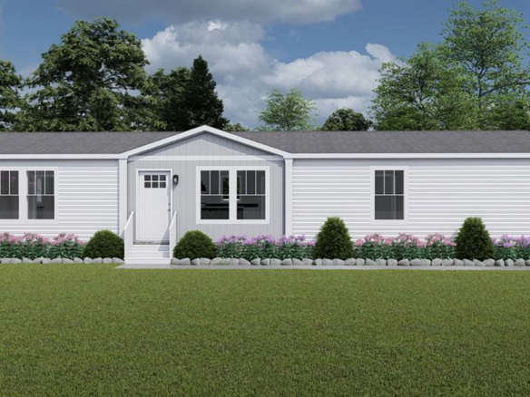 Single-story manufactured home with white siding, gray roof, multiple windows, front steps, and neatly landscaped bushes and flowers.