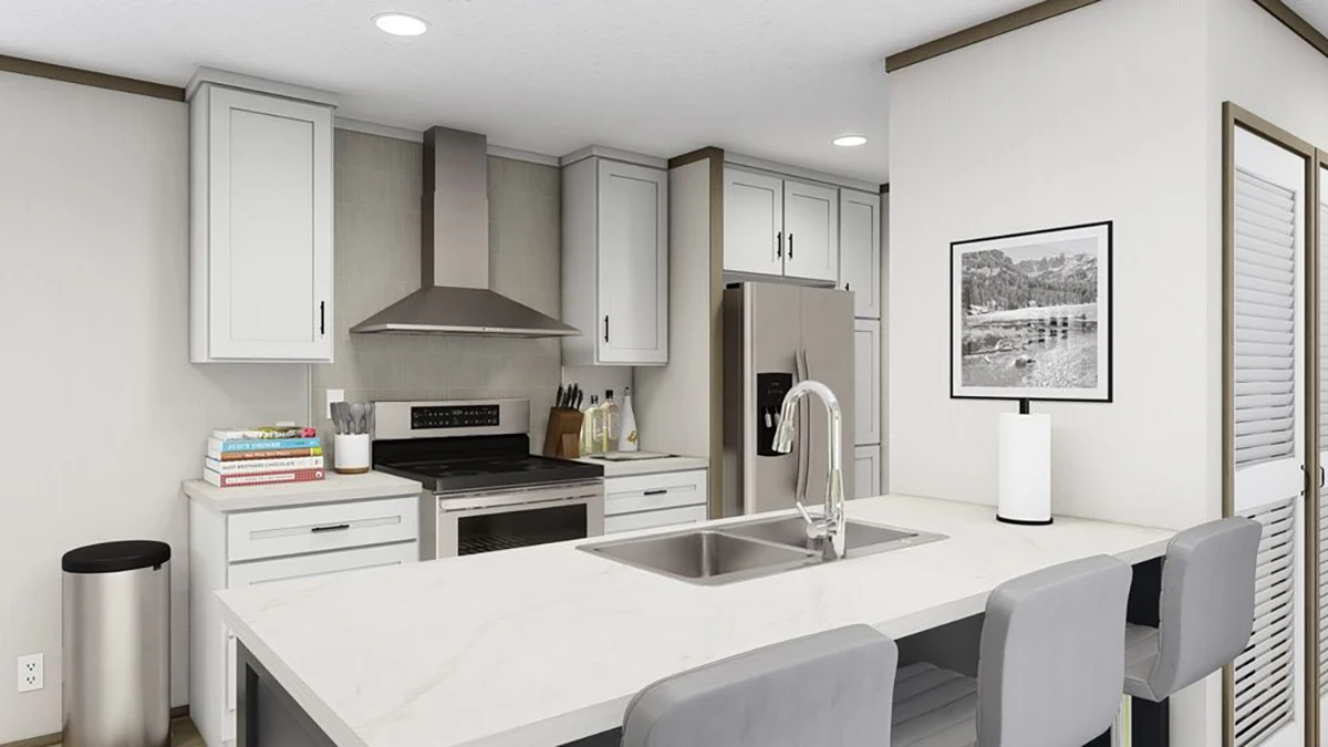 Modern kitchen with white cabinets, stainless steel appliances, an island with a sink and barstools, and a framed photo on the wall.
