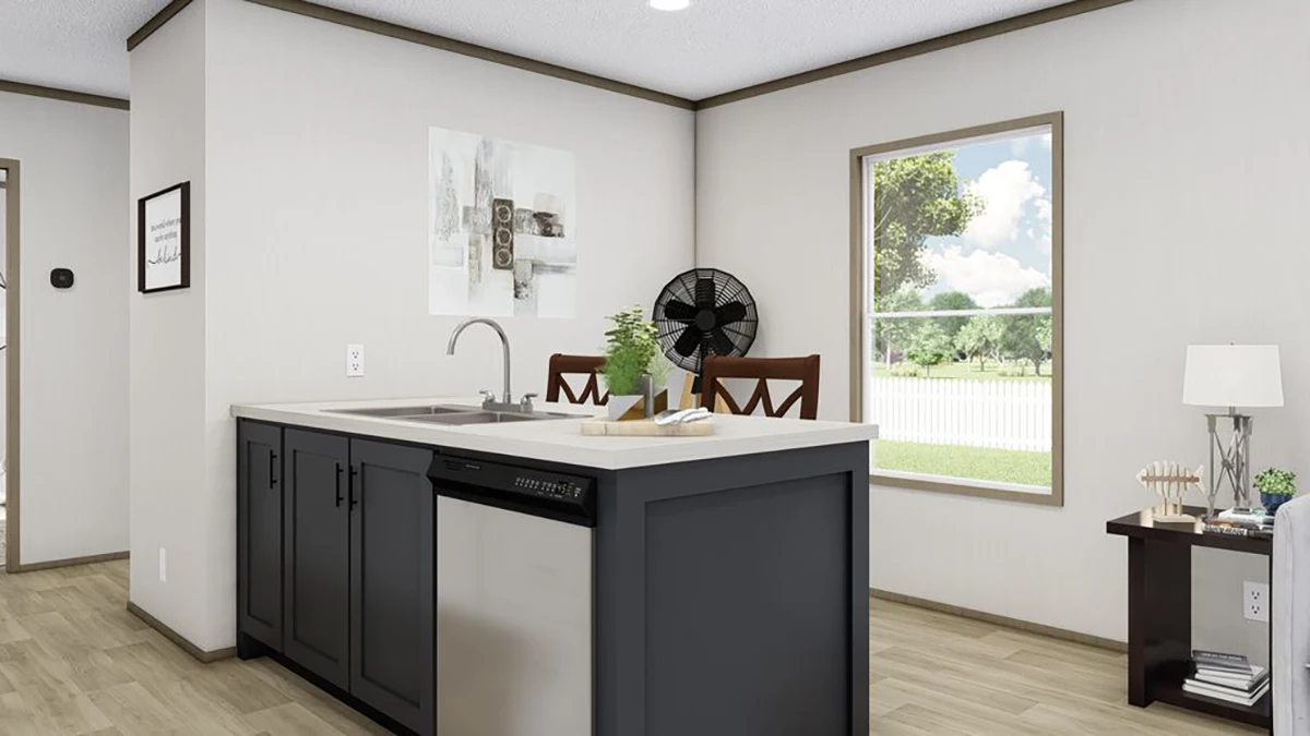 Modern kitchen with an island sink, dishwasher, and dining set. Large window lets in natural light; minimal decor includes a plant and wall art.