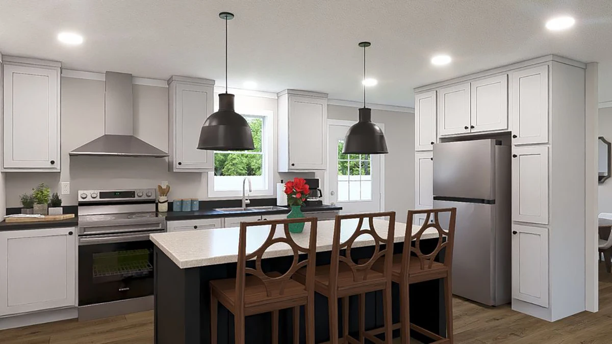 Modern kitchen with white cabinets, stainless steel appliances, a central island with dark pendant lights, and three wooden chairs; a vase of red flowers sits on the island.