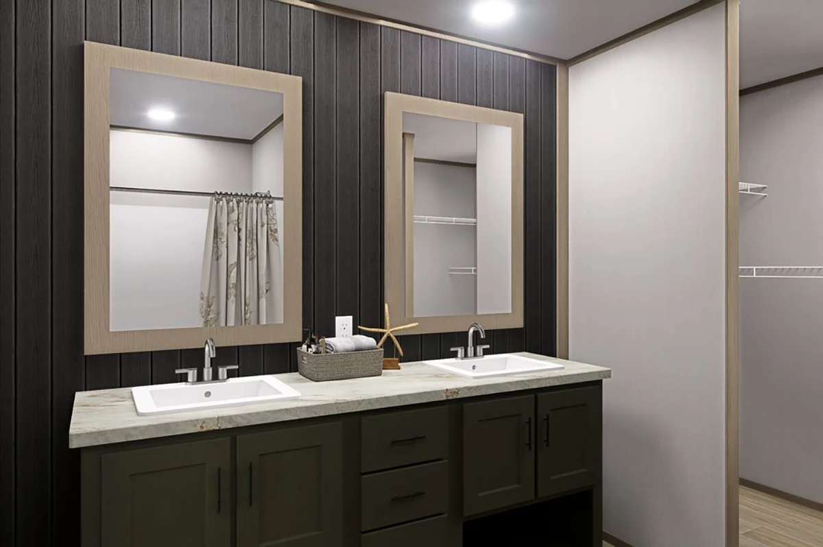Double sink bathroom vanity with two mirrors, dark lower cabinets, light countertop, and wooden wall accents. A shower curtain and open closet shelves are visible in the background.