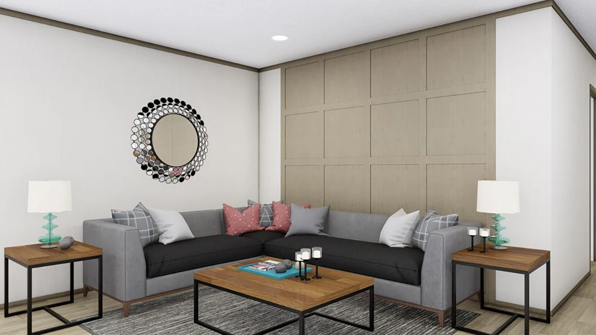 A modern living room with a gray sectional sofa, wooden tables, two table lamps, a circular wall mirror, and a paneled accent wall.
