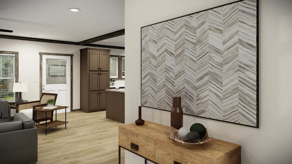 eec50750-ef94-4d2d-9656-94011678096a A modern entryway with light wood floors, a console table with decorative items, a large geometric wall art, and a view into a living area and kitchen.